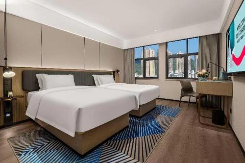 Krevet ili kreveti u jedinici u okviru objekta Echarm Hotel Changsha Electric Power Vocational and Technical College Hyde Park Branch