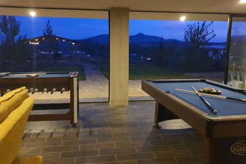 two pool tables in a room with a window at Villa Alejandra Cabaña in Tapalpa
