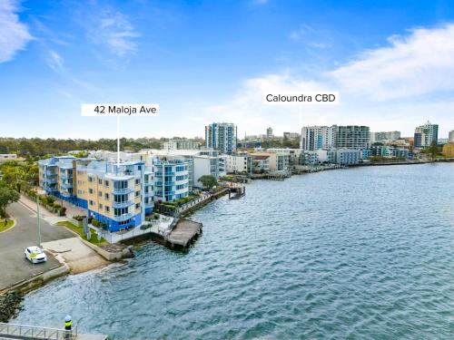 an aerial view of a city next to a body of water at Tripcony Quays in Caloundra