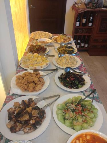 a table with many plates of food on it at Phil Garden Homestay in Dongshan