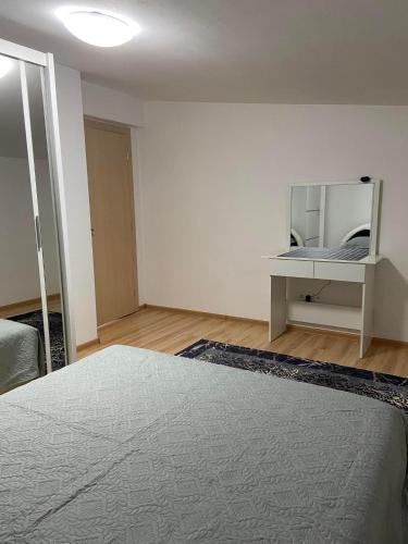 a white room with a bed and a mirror at Stan Na Dan Pehlić - Apartments For The Day Cazin in Cazin