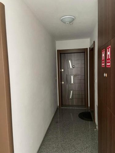 an empty hallway with a door in a building at Stan Na Dan Pehlić - Apartments For The Day Cazin in Cazin