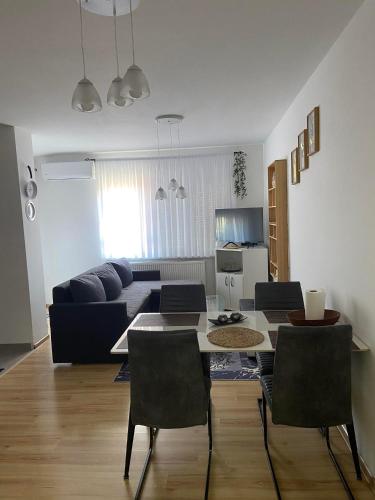 a living room with a table and a couch at Stan Na Dan Pehlić - Apartments For The Day Cazin in Cazin