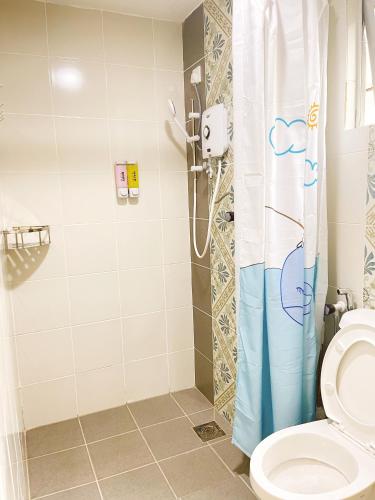 a bathroom with a shower and a toilet at The Floral Dawn Anderson in Kampong Simee