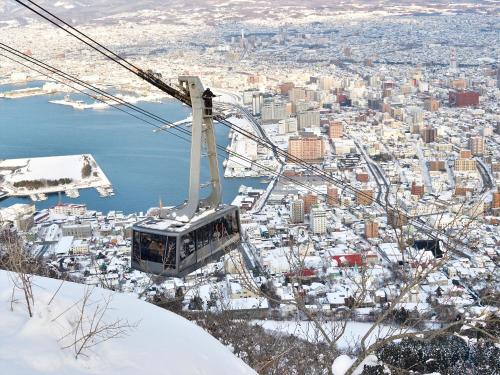 a gondola ride over a city in the snow at Gran Palette Hakodate in Hakodate