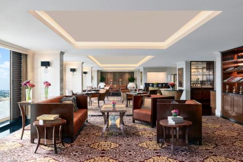 a lobby of a hotel with couches and tables at The Ritz-Carlton, Bangalore in Bengaluru
