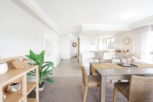 a dining room with a table and chairs at Burleigh View in Gold Coast