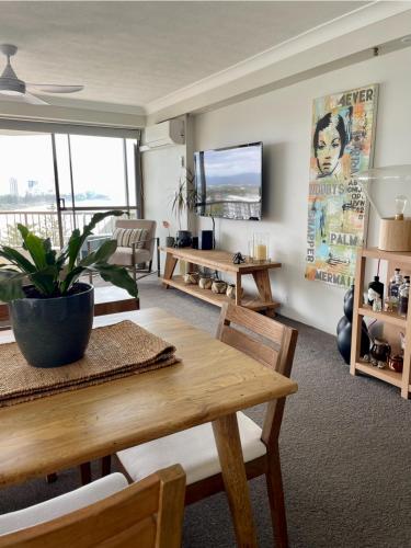 a living room with a table and a couch at Burleigh View in Gold Coast