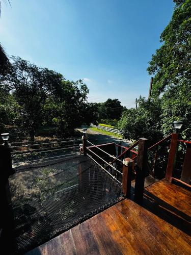 a deck with a view of a river and trees at อิงภูเมาท์เท่นวิว เขาใหญ่ in Ban Khan Takhian