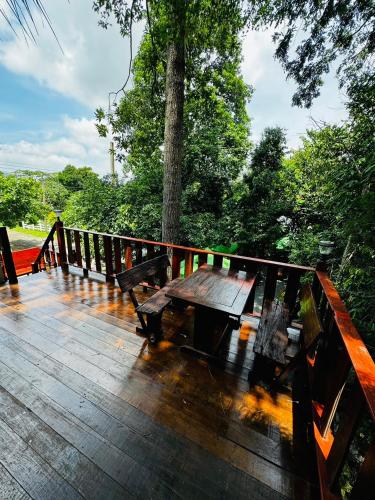a wooden deck with a picnic table on a bridge at อิงภูเมาท์เท่นวิว เขาใหญ่ in Ban Khan Takhian