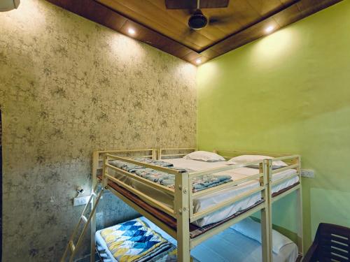 a bedroom with two bunk beds in a room at Shreeji Inn Homestay in Rishīkesh