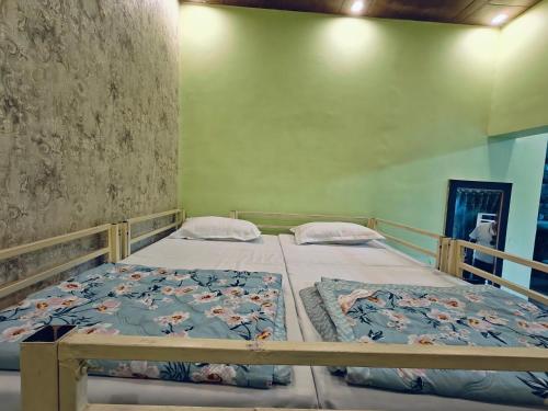 a bedroom with two beds in a room at Shreeji Inn Homestay in Rishīkesh