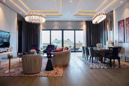 a living room with chandeliers and a lobby at KARAVANSARAY Turkistan Family Hotel - FLYING THEATRE ACCESS in Türkistan