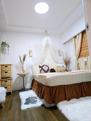 a bedroom with a large bed with a canopy at Cozy Boho Room at the Heart of Vancouver! Private Parking, Self Check-in & just 4 mins to Metrotown! in Burnaby