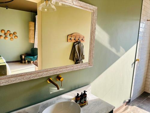 een badkamer met een spiegel en een wastafel bij Lodge Damaraland in Khorixas
