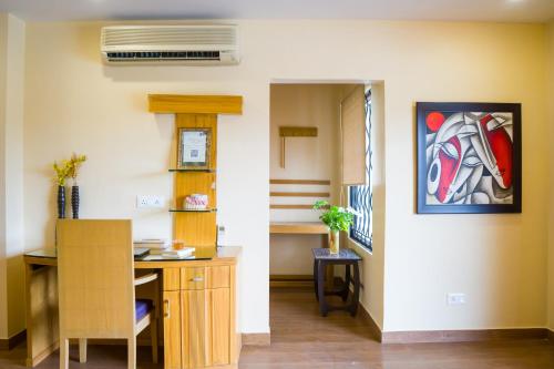 a room with a desk and a painting of a horse at ELIVAAS 5 BHK with Garden & Balconies - Lakeview Manor in Bhīm Tāl
