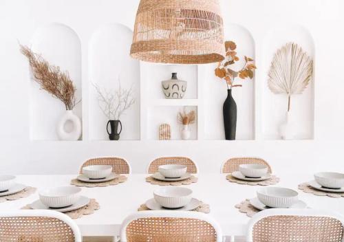 a dining room with a white table and chairs at Our NEW 1940's Lovingly Renovated Cosy Cottage in McLaren Vale