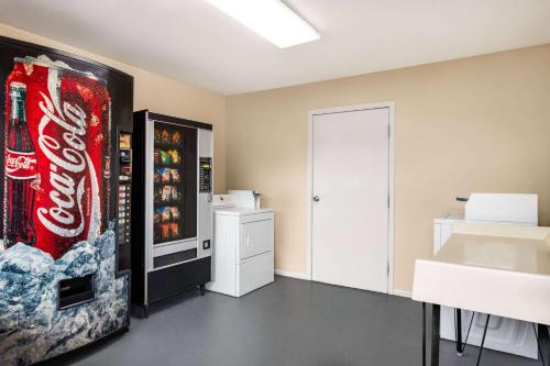 a room with a coca cola refrigerator at Days Inn by Wyndham San Antonio Near Fiesta Park in San Antonio