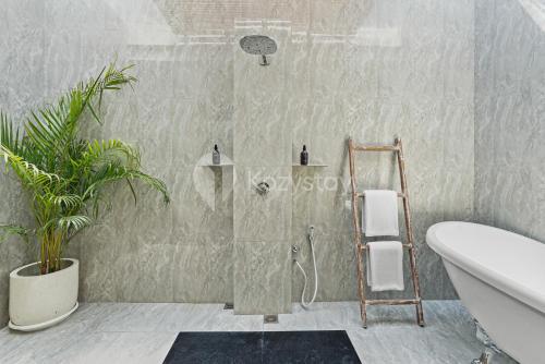 a bathroom with a shower with a ladder in it at Sombra Villa by Kozystay - Sanur in Sanur