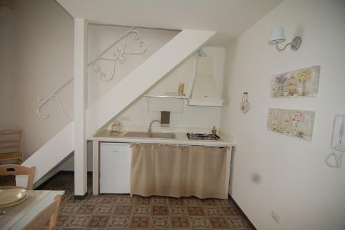 a kitchen with a sink and a staircase with a sink at Domus Aurea in Martina Franca