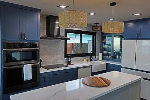 a kitchen with blue cabinets and a white counter top at Oahu's Best Kept Secret in Laie