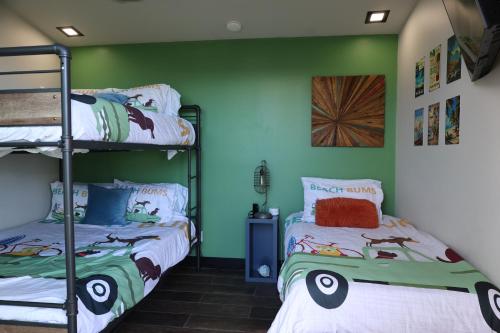 two bunk beds in a room with green walls at Oahu's Best Kept Secret in Laie