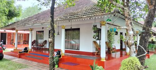 a small house with a red and white at MARARI SEA SCAPE HOMESTAY Beach in Mararikulam