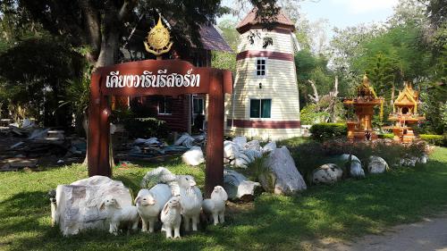 a group of sheep standing in front of a sign at Keangvarin Resort in Ban Kaeng Manao