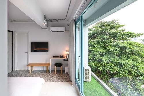 an open balcony with a table and a desk at Mowa Bangkok in Bangkok