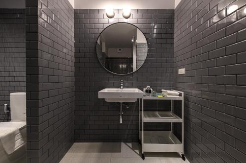 a bathroom with a sink and a mirror at Mowa Bangkok in Bangkok