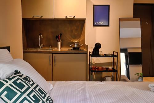 a kitchen with a sink and a bed in a room at Central Studio Apartments by Parkside Boutique in Skopje