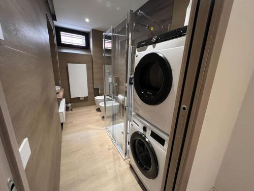 a bathroom with a washer and dryer in a trailer at Castello Estense Luxury Apartment - Centro in Ferrara