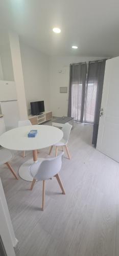 an office with two tables and chairs in a room at Casa huerta lola in Murcia