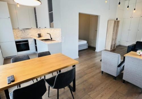 a kitchen and dining room with a table and chairs at Arensburg Boutique Hotel & Spa in Kuressaare
