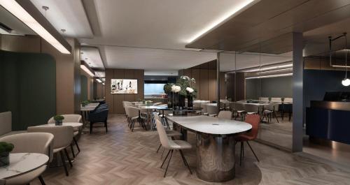 a restaurant with tables and chairs in a room at Holiday Inn Express Shanghai Jing'an Temple by IHG in Shanghai