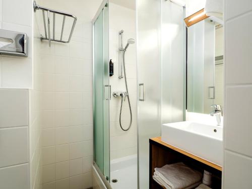 a bathroom with a shower and a sink at Mercure Czestochowa Centrum in Częstochowa