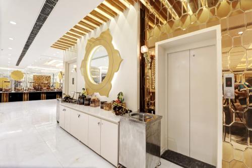 a large room with a vanity and a mirror at Hotel The Rasa at Vasundhara in Ghaziabad