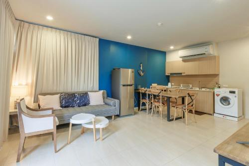 a living room with a couch and a table and a kitchen at Beach Front Condo, Baan Thew Talay, Perfect Choice for Family and Couple in Ban Bo Khaem