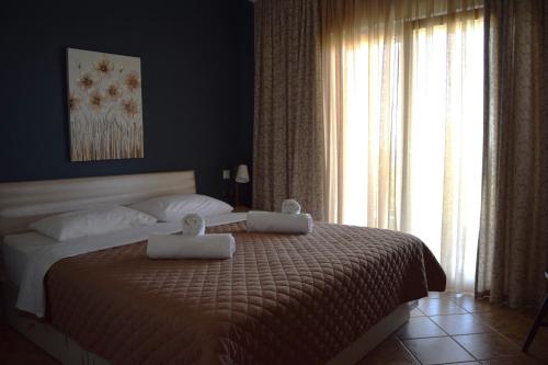 a bedroom with a large bed with two towels on it at Apartment Achilles in Litochoro