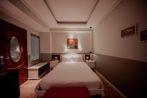 a bedroom with a white bed in a room at Au Lac Boutique Hotel in Ho Chi Minh City