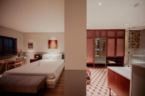 two images of a bedroom with a bed and a bathroom at Au Lac Boutique Hotel in Ho Chi Minh City