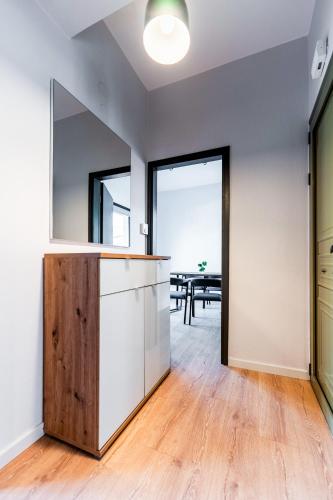 an open kitchen and dining room with a table in the background at George House in Litochoro