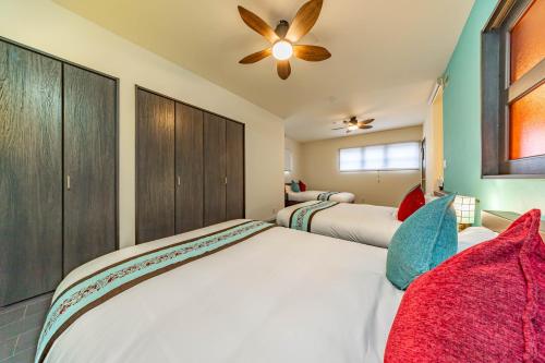 a bedroom with two beds and a ceiling fan at 1688House美ら海 in Motobu