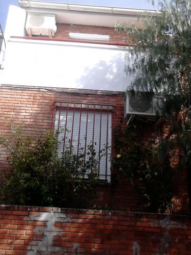 a brick building with a window with bars on it at Casa Los Pinos in Siles