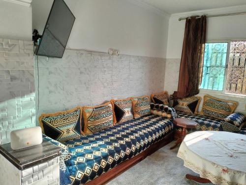 een woonkamer met een bank met kussens erop bij Perfect only family apartment & air cooling in Marrakesh
