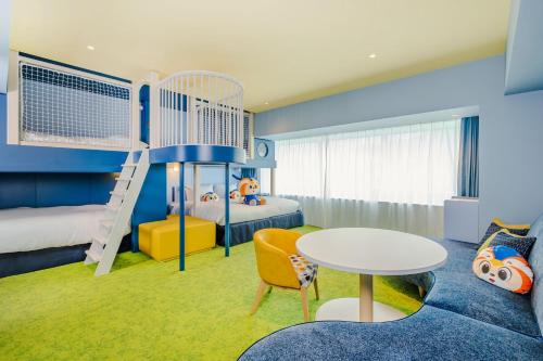 a kids room with a bunk bed and a table at Stadium City Hotel Nagasaki in Nagasaki