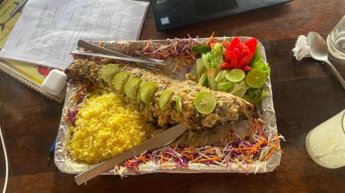 a plate of food with rice and vegetables on a table at Village Susegat Beach Resort in Morjim
