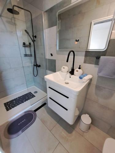 a small bathroom with a sink and a shower at Rooms Katja in Gradac