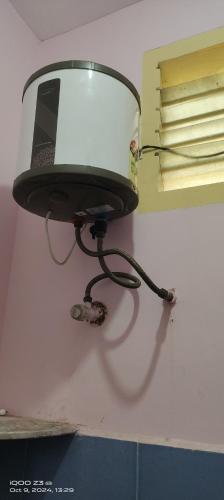 a lamp on a wall with a laptop on it at chendur Residency in Tiruvannāmalai