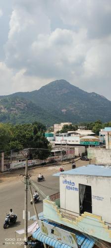 a view of a city with a mountain in the background at chendur Residency in Tiruvannāmalai